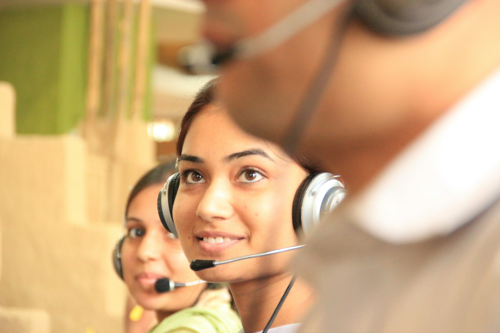 woman in black headphones checking eligibility of patient